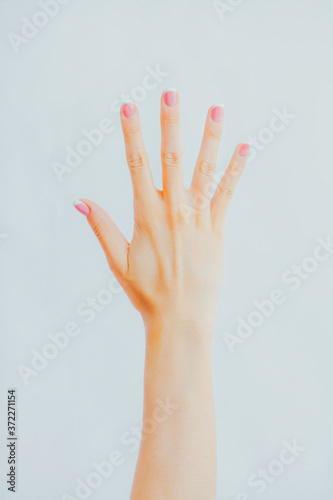 Woman's hand shows five fingers