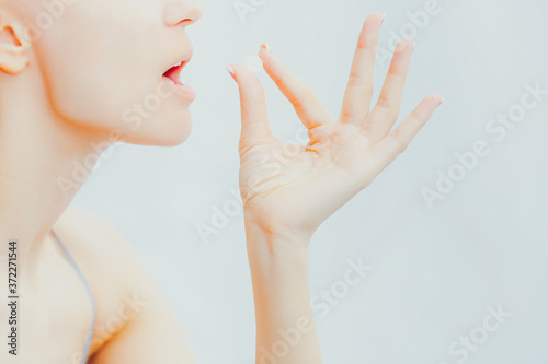 Woman takes white round pill