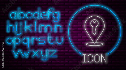 Glowing neon line Location key icon isolated on brick wall background. The concept of the house turnkey. Neon light alphabet. Vector.