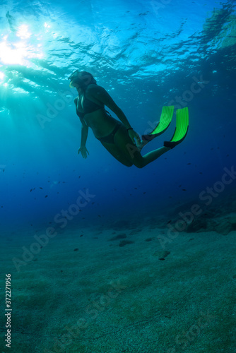 A young woman is diving