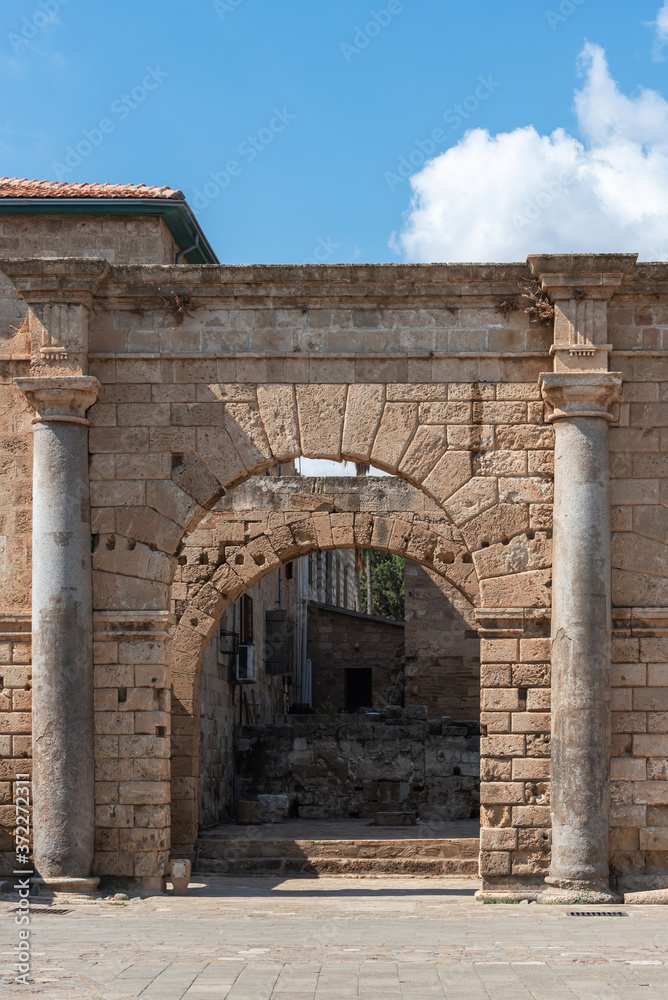 Arched entrance with Doric columns to a ruined antique building