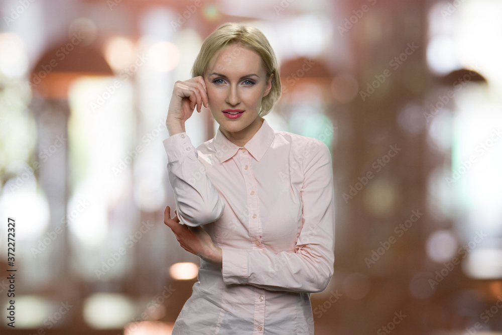 Portrait of young sexy woman looking at camera. Front view of beautiful seductive woman posing on blurred brown background. Portrait of young sexy woman looking at camera. Front view of beautiful seductive woman posing on blurred brown background.