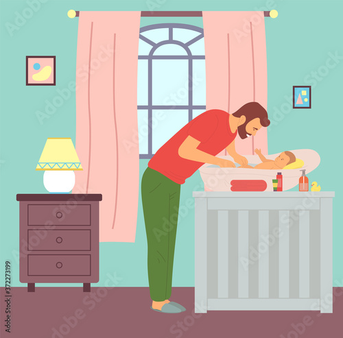 Young father bathing kid in baby bath. Dad washing newborn son. Caring and parenting concept. First steps of fatherhood. Chest of drawers with lamp, window with curtains, children s room interior