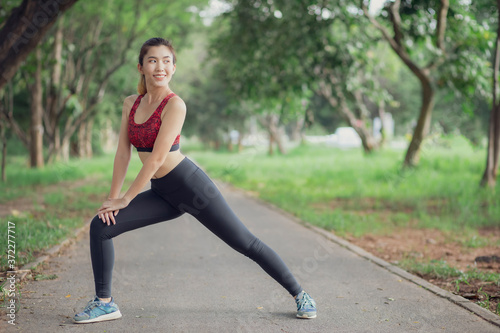 Asian women are doing yoga in the park to keep them healthy and in good shape. 