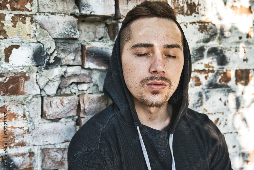 sad urban man with hood on head. Mystery man sad urban man with hood on head. Mystery man