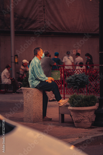 isolated man sitting in the street
