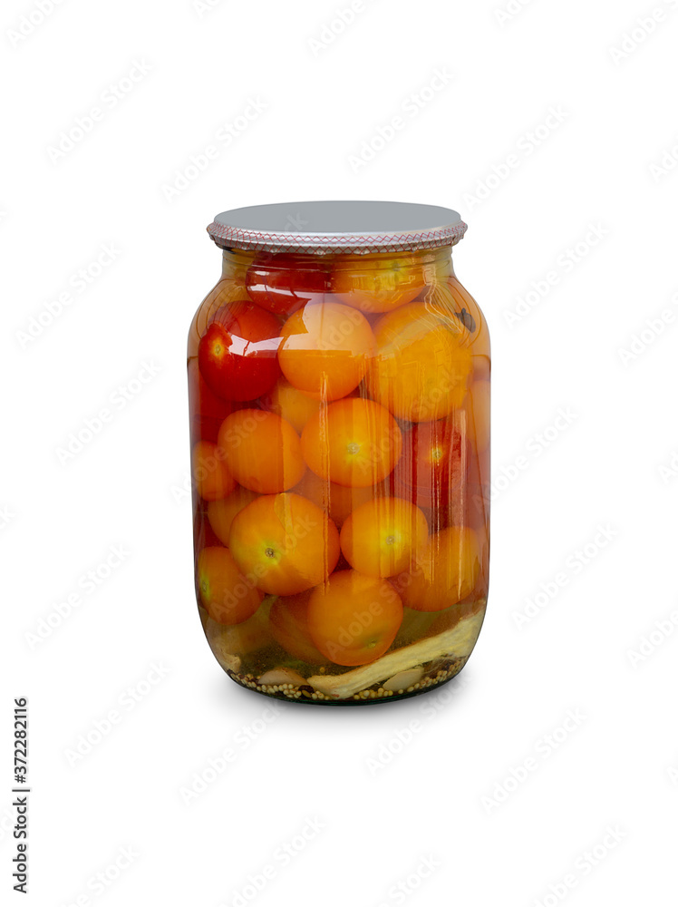 Tomatoes in a glass jar, artisanal preparation of pickles Tomatoes in a glass jar, artisanal preparation of pickles