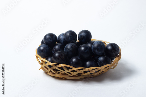 Wallpaper Mural Plum in a wicker basket. Photo on a white background. Summer harvest Torontodigital.ca