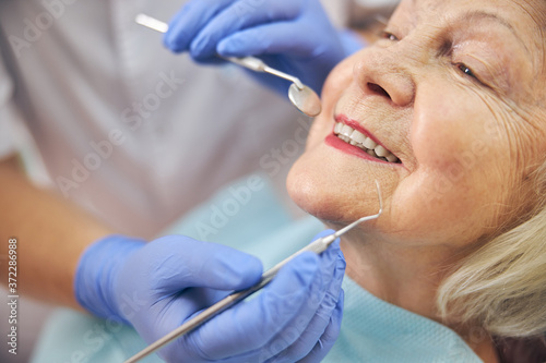 Senior female patient in modern dental clinic
