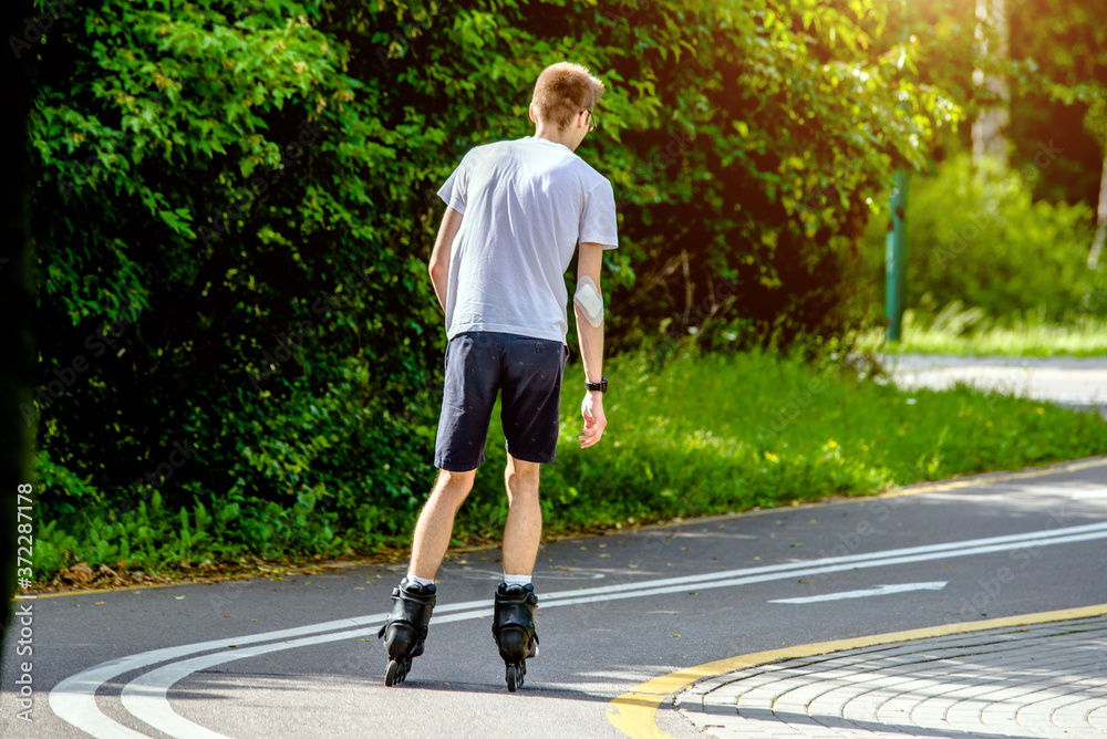 Fototapeta premium man roller skating in the summer Park 