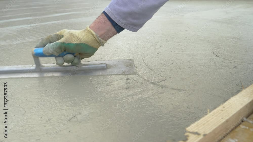 SLOW MOTION, CLOSE UP, DOF Unrecognizable worker levels the large