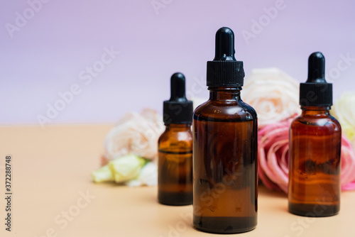 Creating homemade cosmetics with natural extracts. Serum with roses petals. Skin care concept. Natural organic homemade cosmetics concept