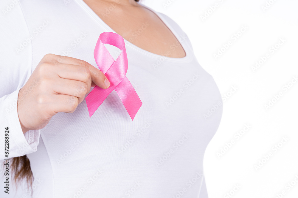 Breast cancer awareness ribbon on woman chest isolated over white background. Medical, healthcare for advertising concept. Breast cancer awareness ribbon on woman chest isolated over white background. Medical, healthcare for advertising concept.