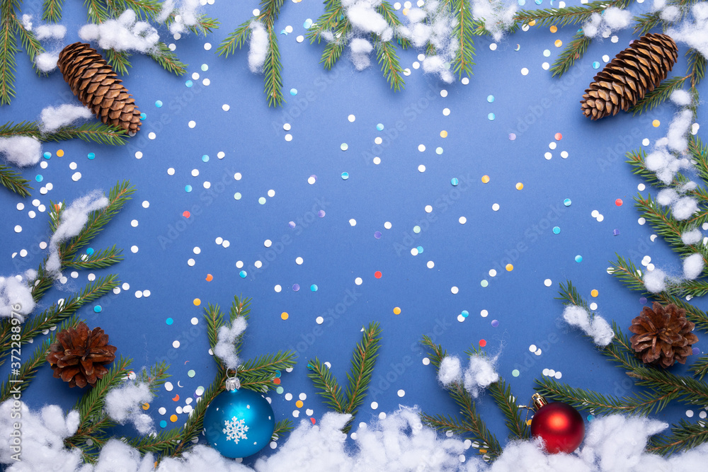 christmas background with pine and spruce cones fir branches and confetti