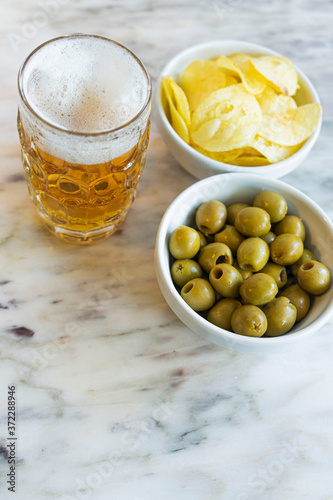 Beer with chips and olives