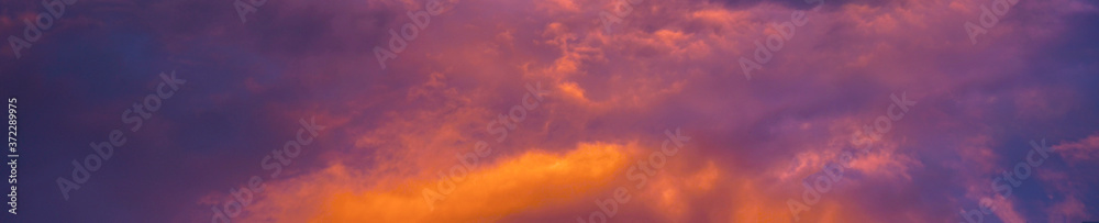 Abstract colorful background. Blue purple orange sky at sunset background. Sunset in the clouds.