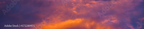 Abstract colorful background. Blue purple orange sky at sunset background. Sunset in the clouds.