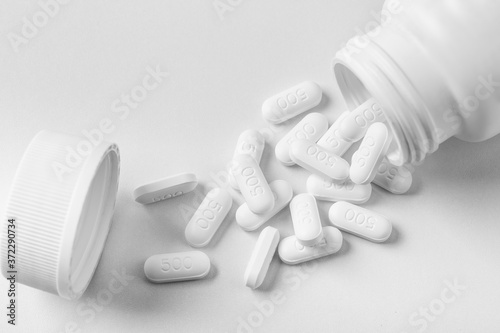 Paracetamol 500 mg with bottle on white background. Isolated paracetamol. White pills.