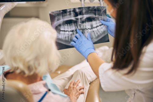 Woman is having teeth examined at dentist