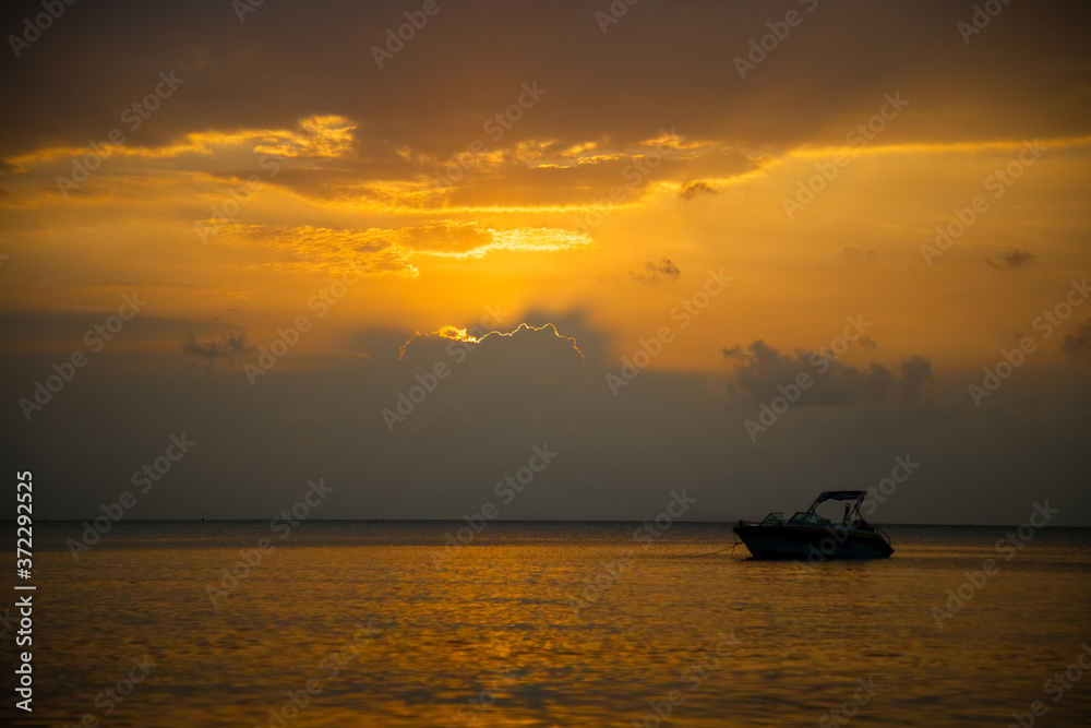 beautiful golden sunset in the sea. speed boat in the rays of the evening sun.