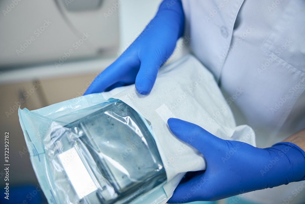 Medical instruments in hands in blue gloves