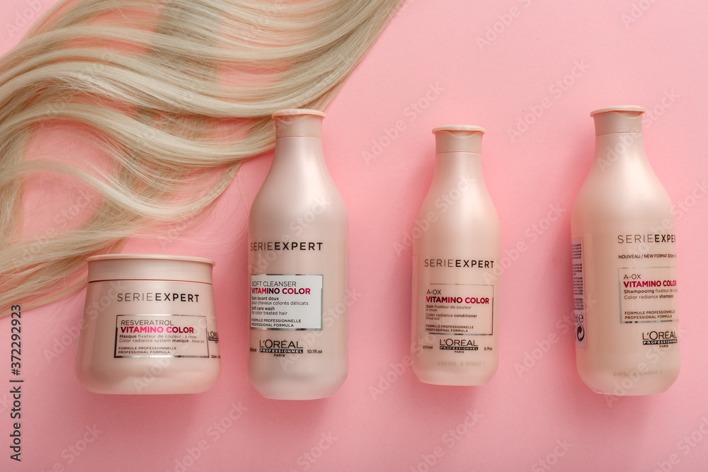 L'oreal professionnel Serie Vitamino Color hair professional hair shampoo mask.strand of blonde hair on pink background.Pink cosmetics bottles. Flat lay copy space Stock Photo | Adobe Stock