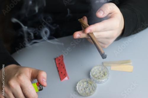 Smoking cannabis in blunt paper, marijuana recreational use