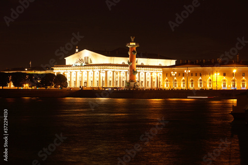 Landmarks in the city of St. Petersburg in Russia, the embankment of the Neva River with Rastral columns on the other side at night with illumination