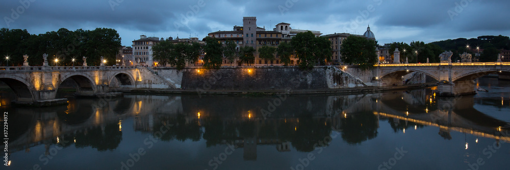 View of Tiber river at night. A panoramic view of the Tiber river between the Ponte Sant'Angelo bridge and the Ponte Vittorio Emanuele II bridge, Rome, Italy