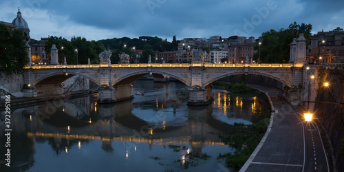Night lights of the Ponte Vittorio Emanuele II bridge. View of the Tiber river and the Ponte Vittorio Emanuele II bridge at night, Rome, Italy