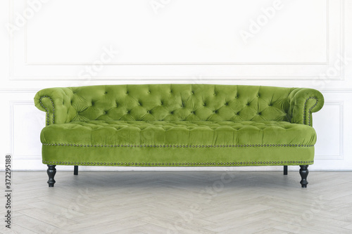 Green sofa on a white wall background