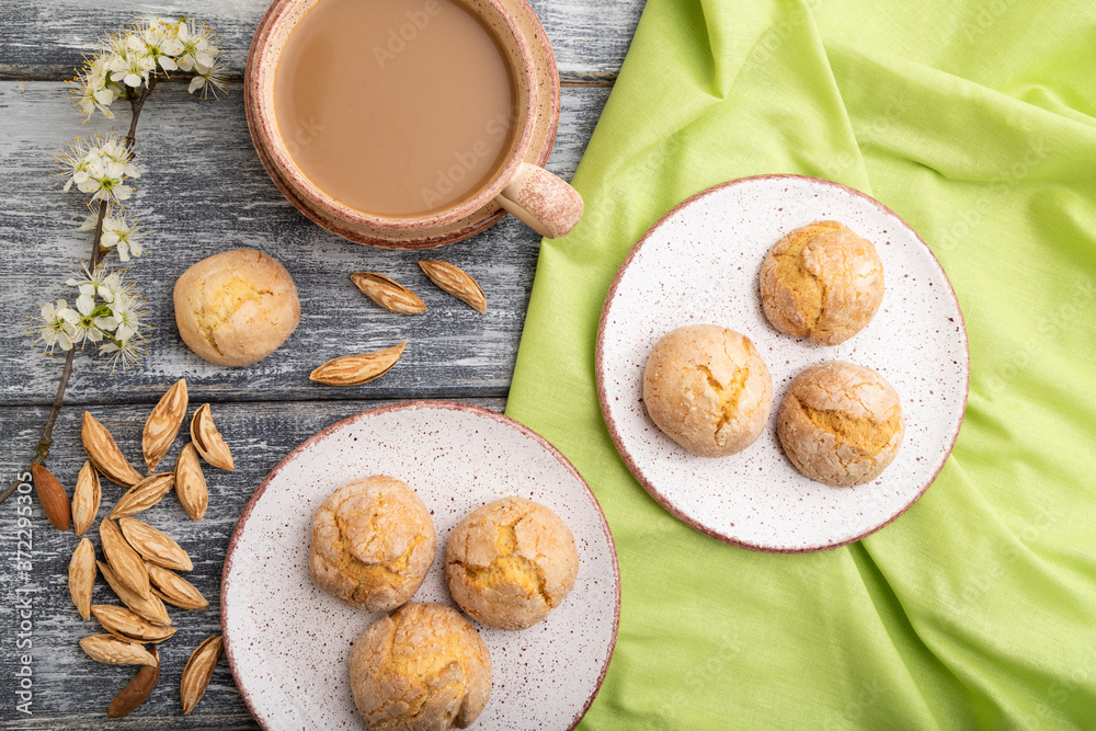 Almond cookies and a cup of coffee on a gray wooden background. Top view.