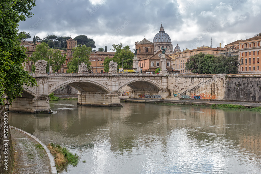 View of the Basilica St Peter in Rome. View of the Tiber river and the Ponte Vittorio Emanuele II bridge, Rome, Italy