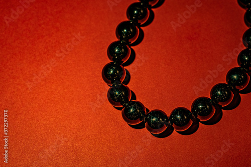 Black beads with red background
