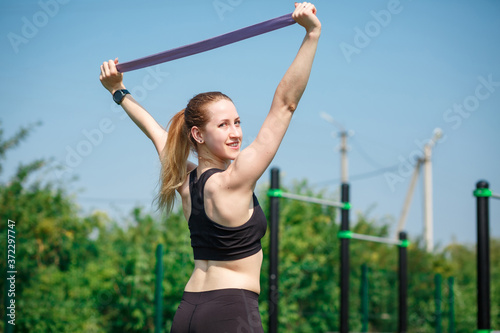 Young woman in sports outfit doing morning workout outdoors.