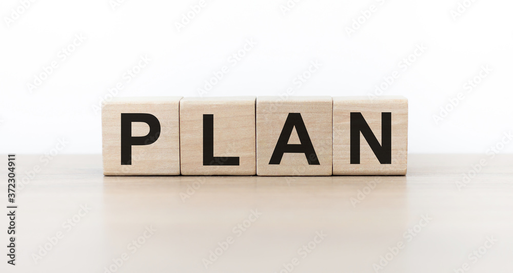 Wooden cubes with PLAN text on table. Goals, success, strategy, solution and business concept. Wooden cubes with PLAN text on table. Goals, success, strategy, solution and business concept.