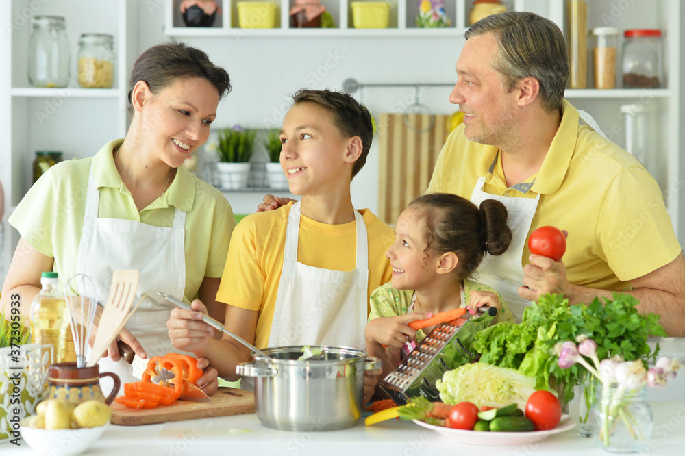 Portrait of cute family cooking together in kitchen Portrait of cute family cooking together in kitchen