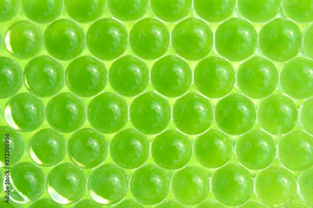 Fototapeta premium Macro of green gel balls. Abstract geometric hydrogel background
