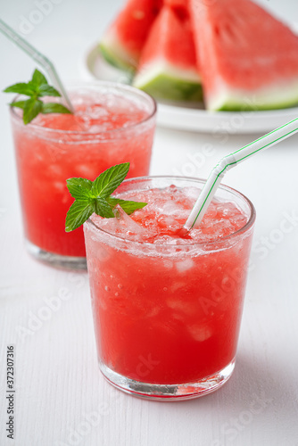 Summer cold drink with watermelon and mint on a wooden background.