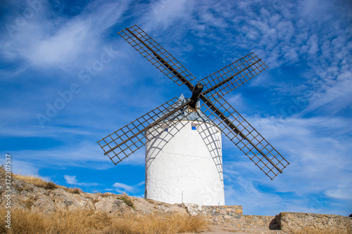 Photo of some beautiful and historic windmills located in Consuegra, Toledo, Spain during a sunny day of summer in a natural place. 