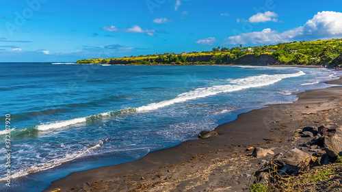 Fototapeta Naklejka Na Ścianę i Meble -  A view along a deserted volcanic beach in St Kitts