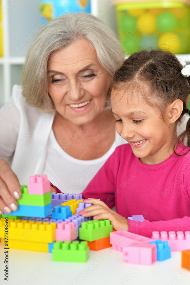Close up portrait of cute girl and grandmother playing Close up portrait of cute girl and grandmother playing