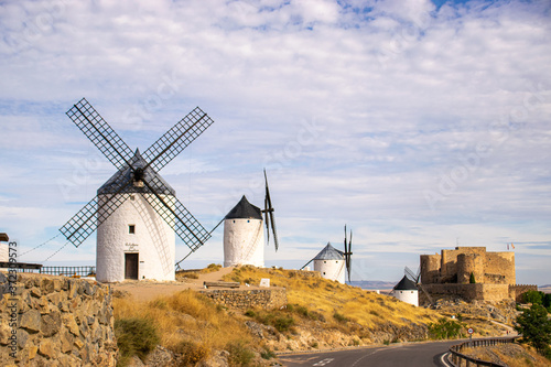 Photo of some beautiful and historic windmills located in Consuegra, Toledo, Spain during a sunny day of summer in a natural place. 