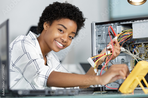 happy young female pc technician looking at camera