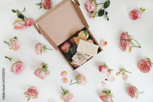 Natural homemade organic soap with pink roses and petals on white background. Spa concept, top view, flatlay © paralisart