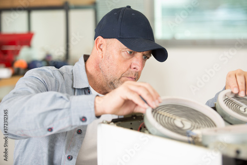 man in a cap worker with a machine