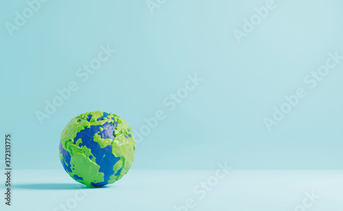Fototapeta Naklejka Na Ścianę i Meble -  Plasticine earth on color paper background minimal style 3D render