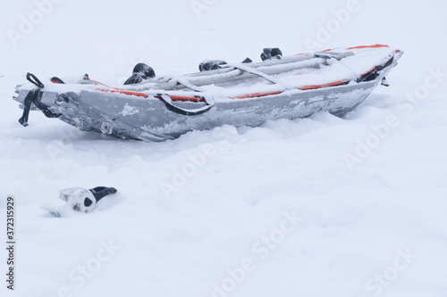 Emergency rescue sledge on the snow with no people and skis burried under snow. Rescue equipment and tools.