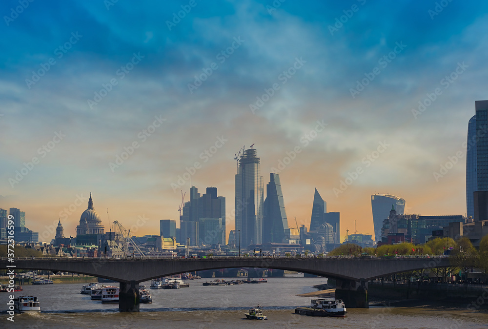 A view along the Thames in London, UK at dusk.