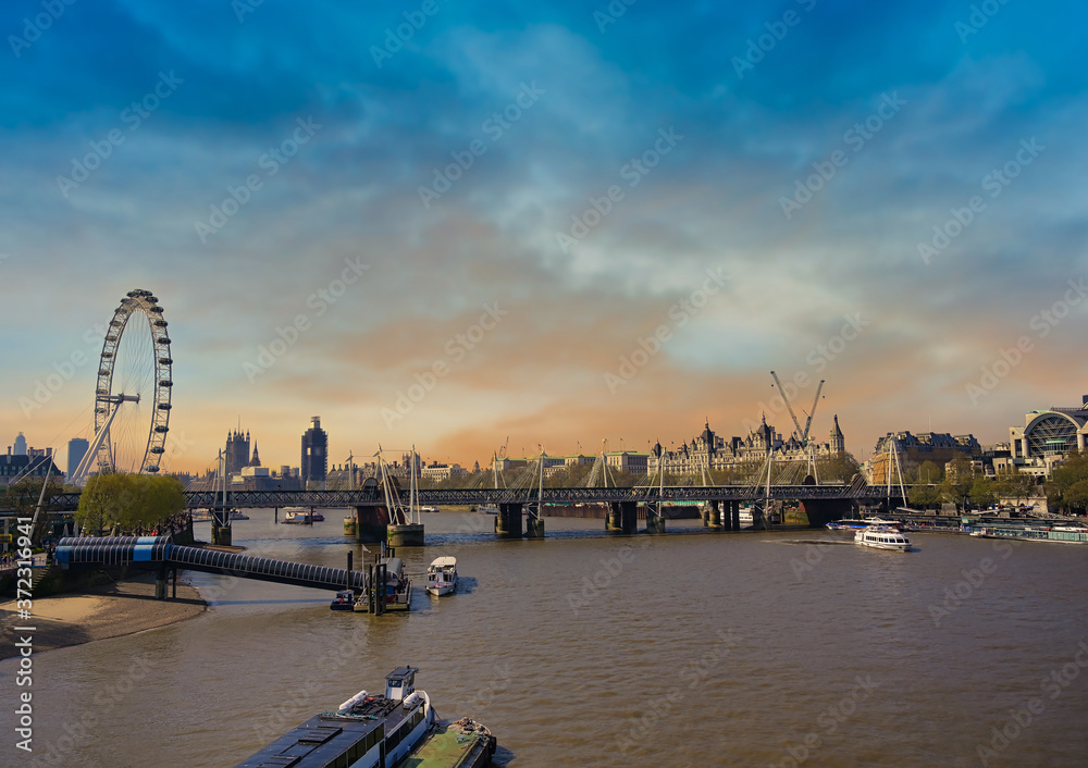 A view along the Thames in London, UK at dusk.